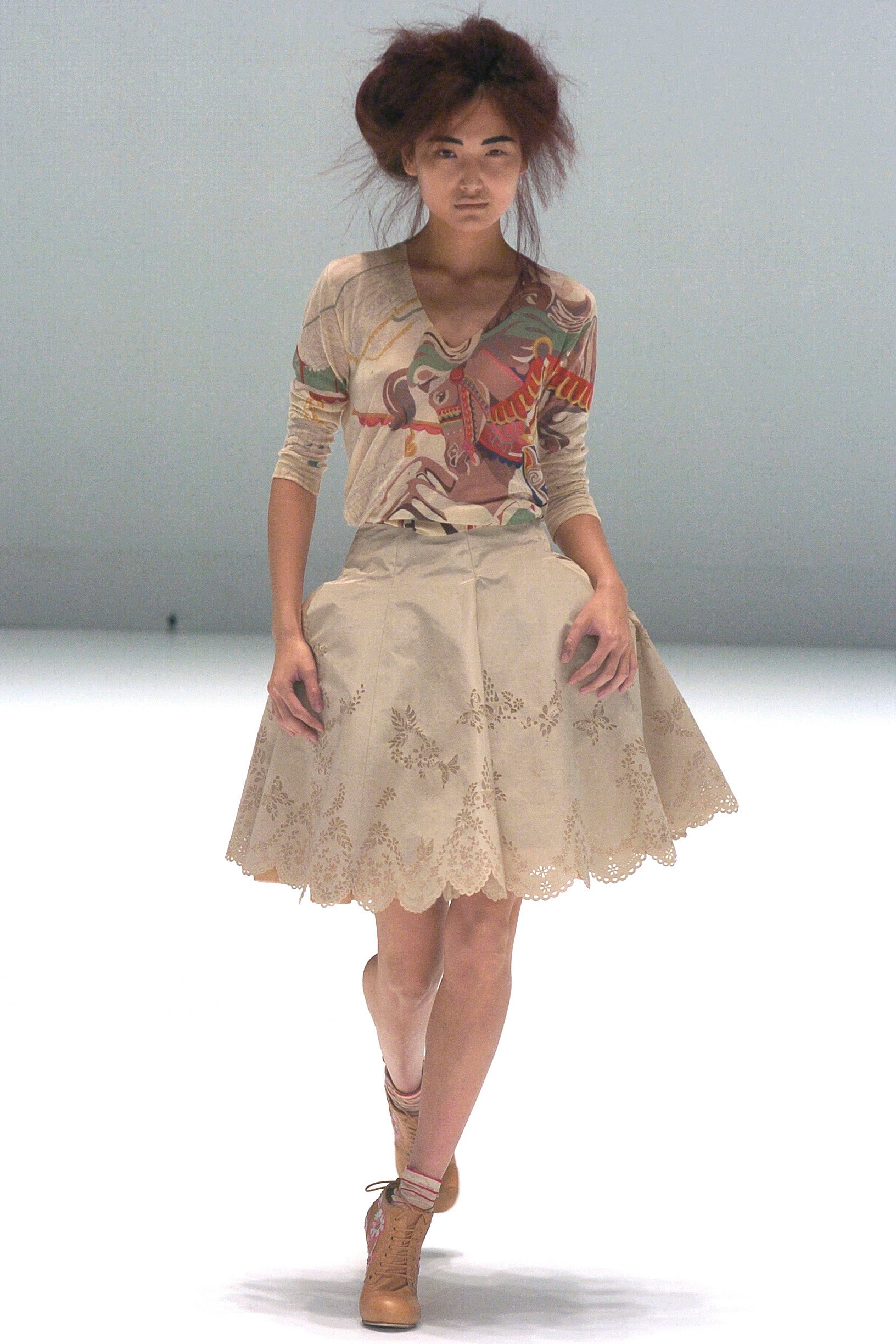 multi-colored fitted top and beige skirt