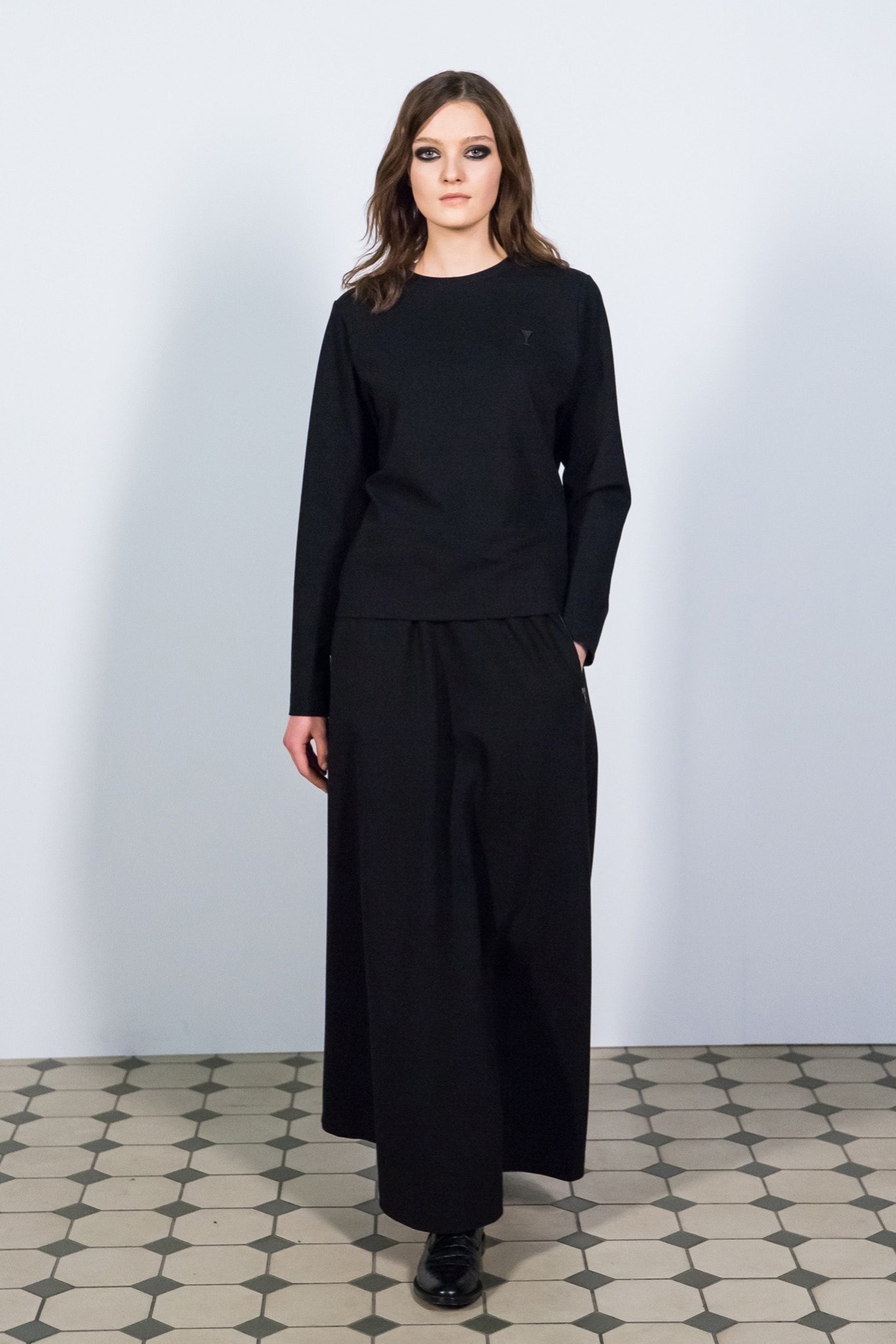 black relaxed top and pleated skirt