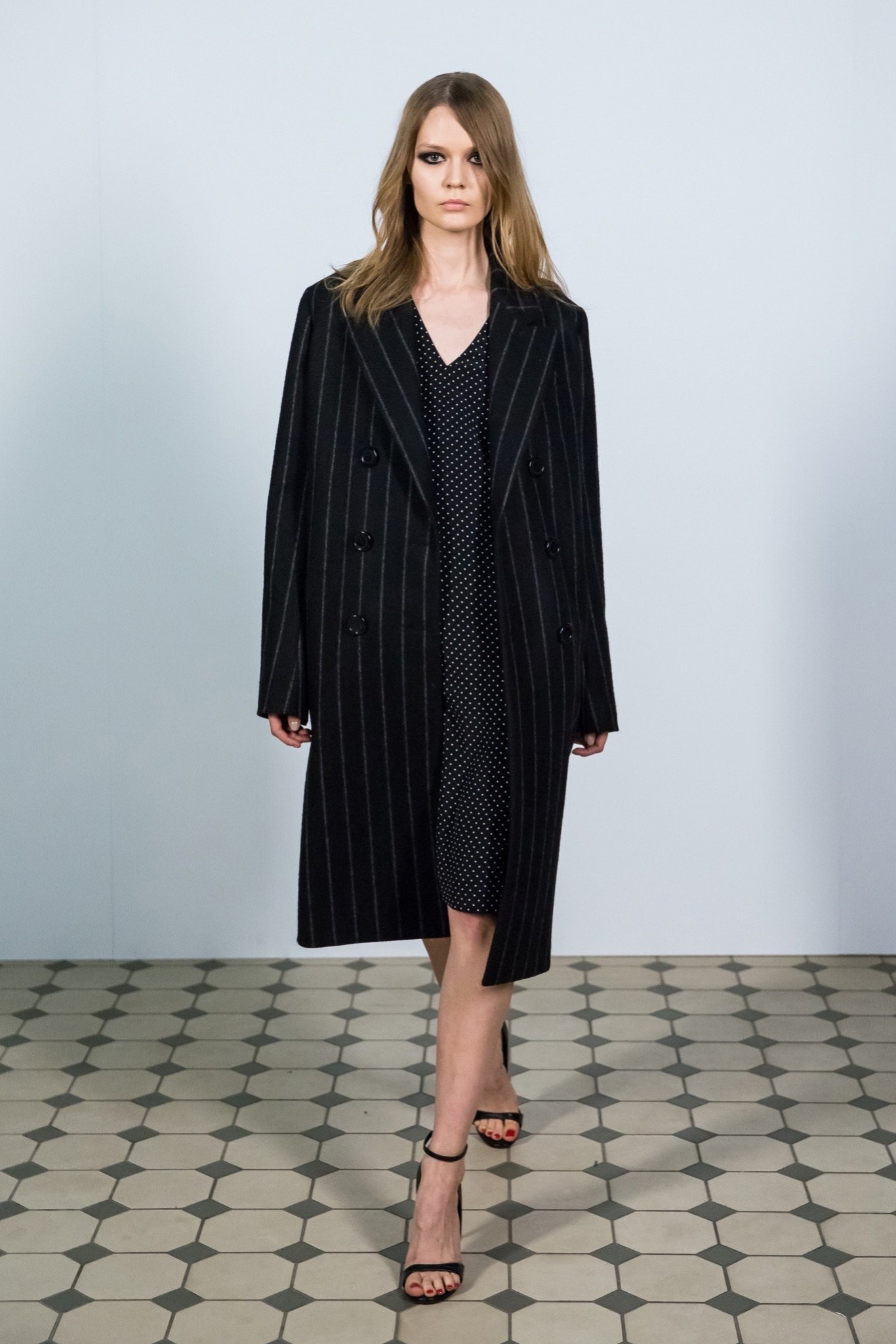 black wool coat with polka-dot dress