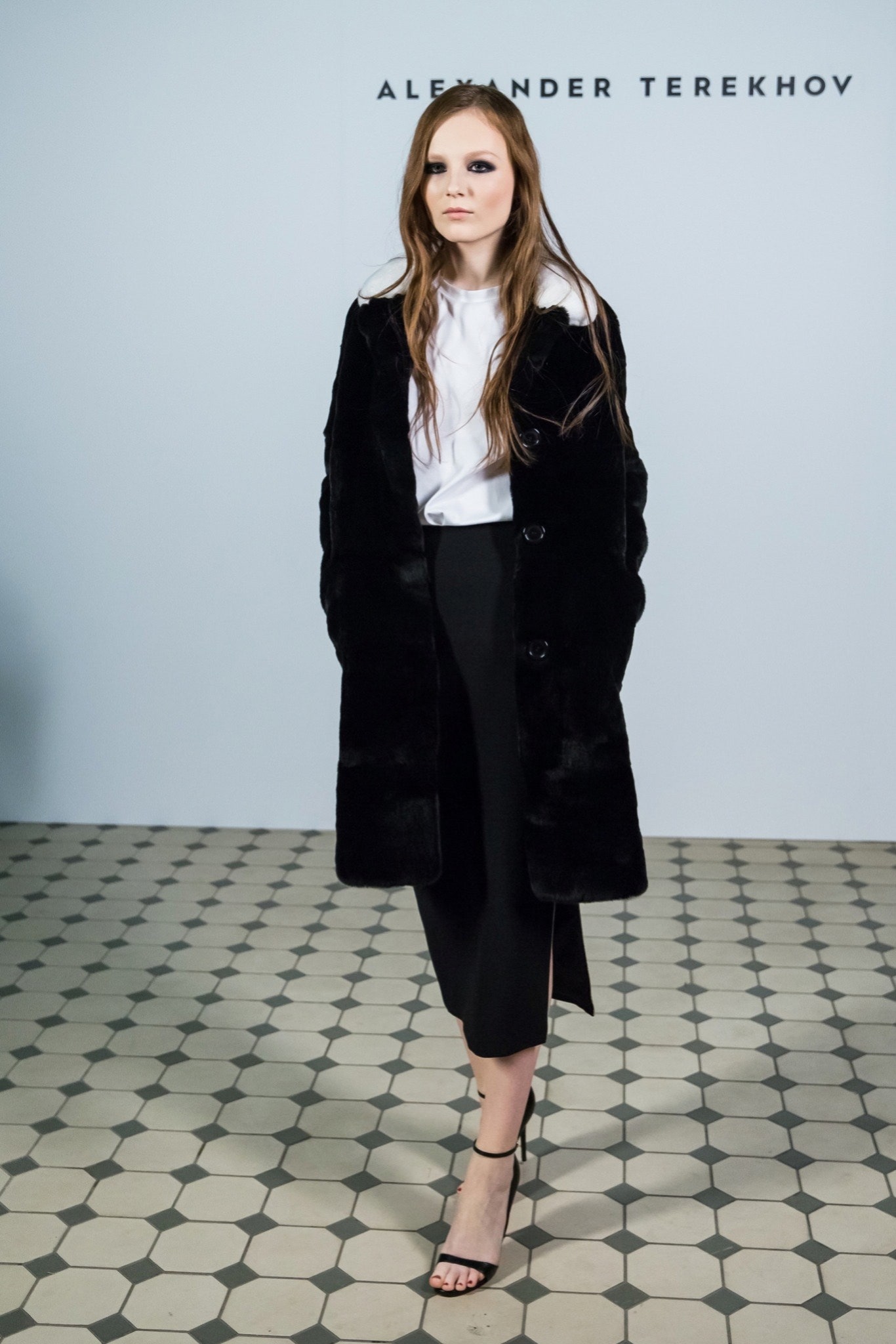 black faux-fur coat with white blouse
