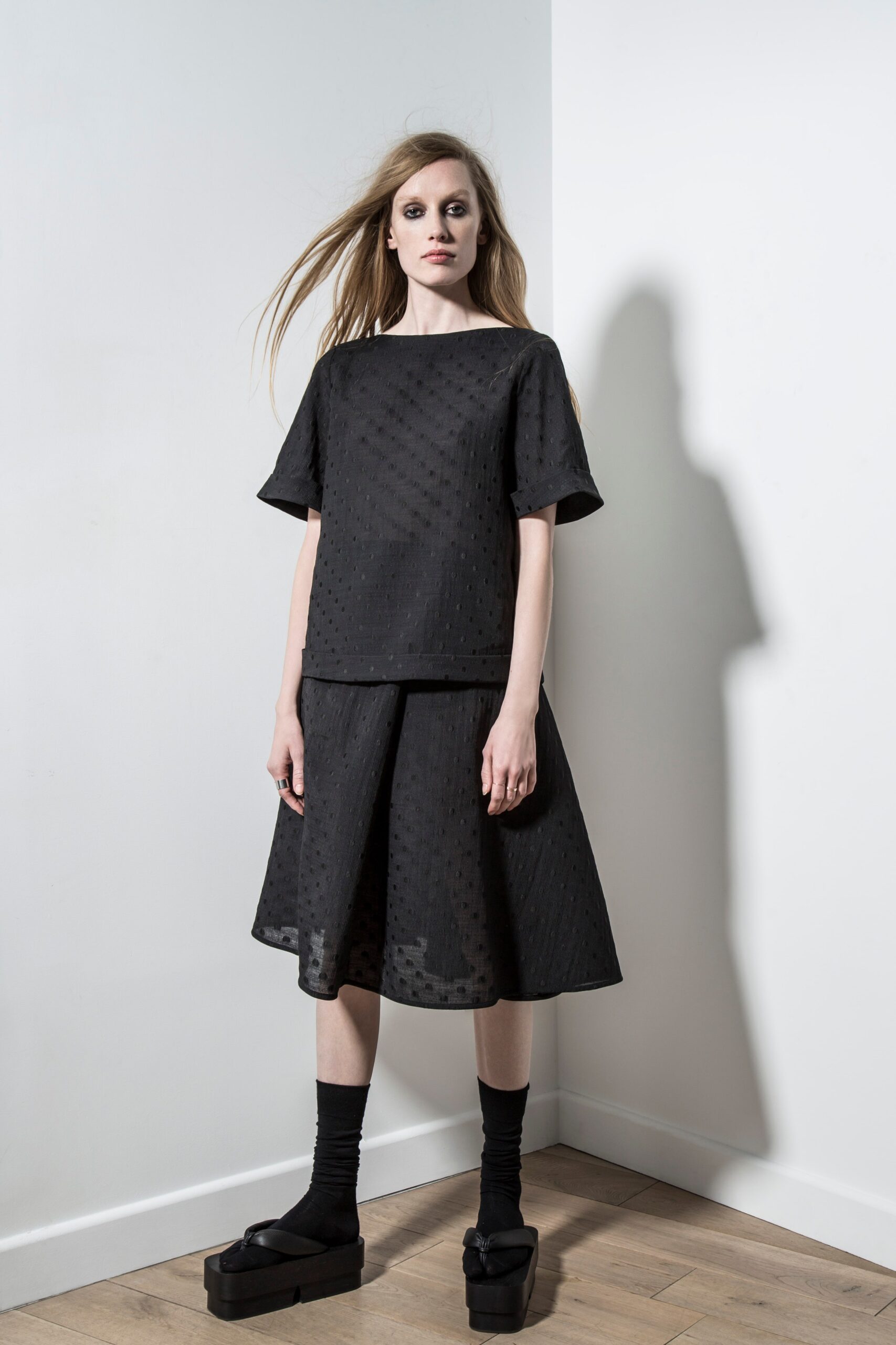 black relaxed top and a-line skirt