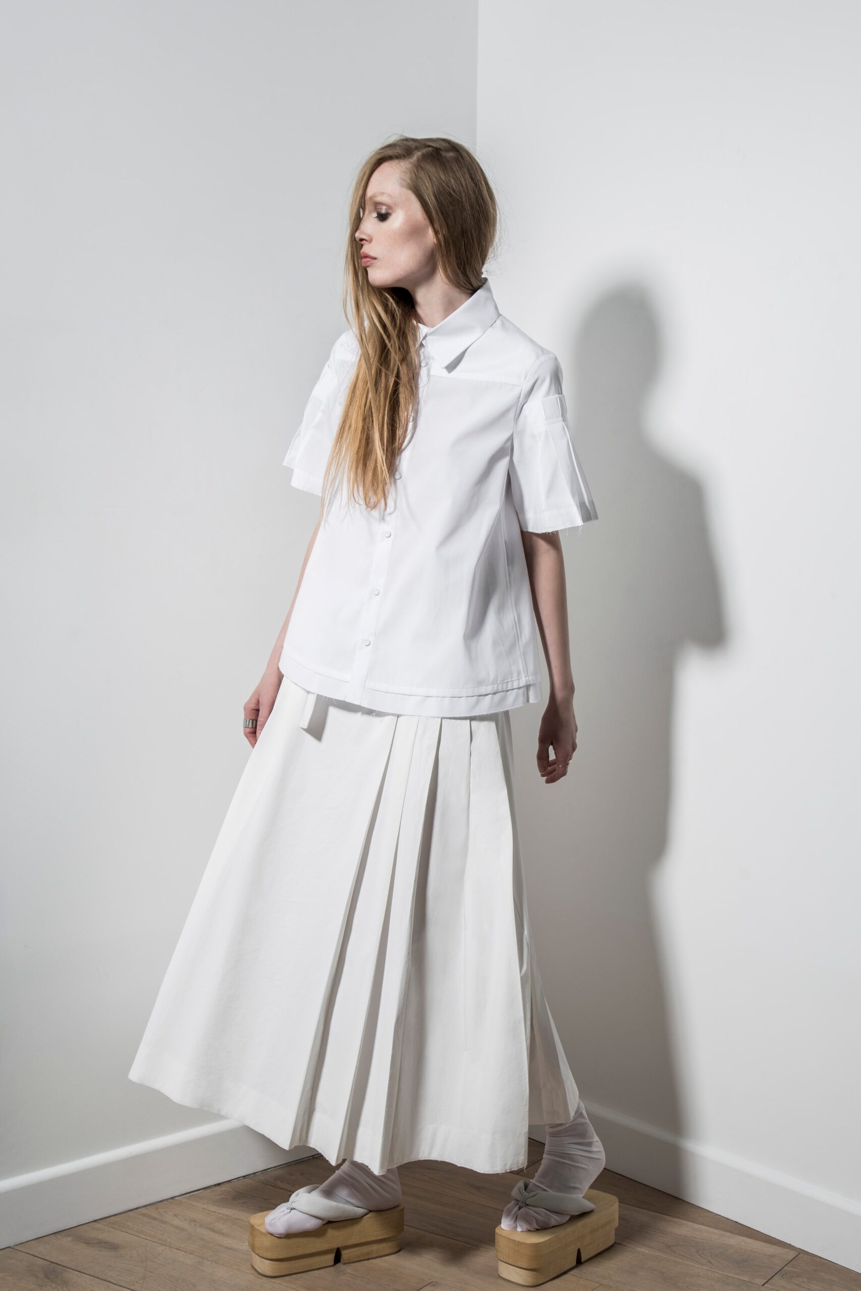 white relaxed shirt and pleated skirt