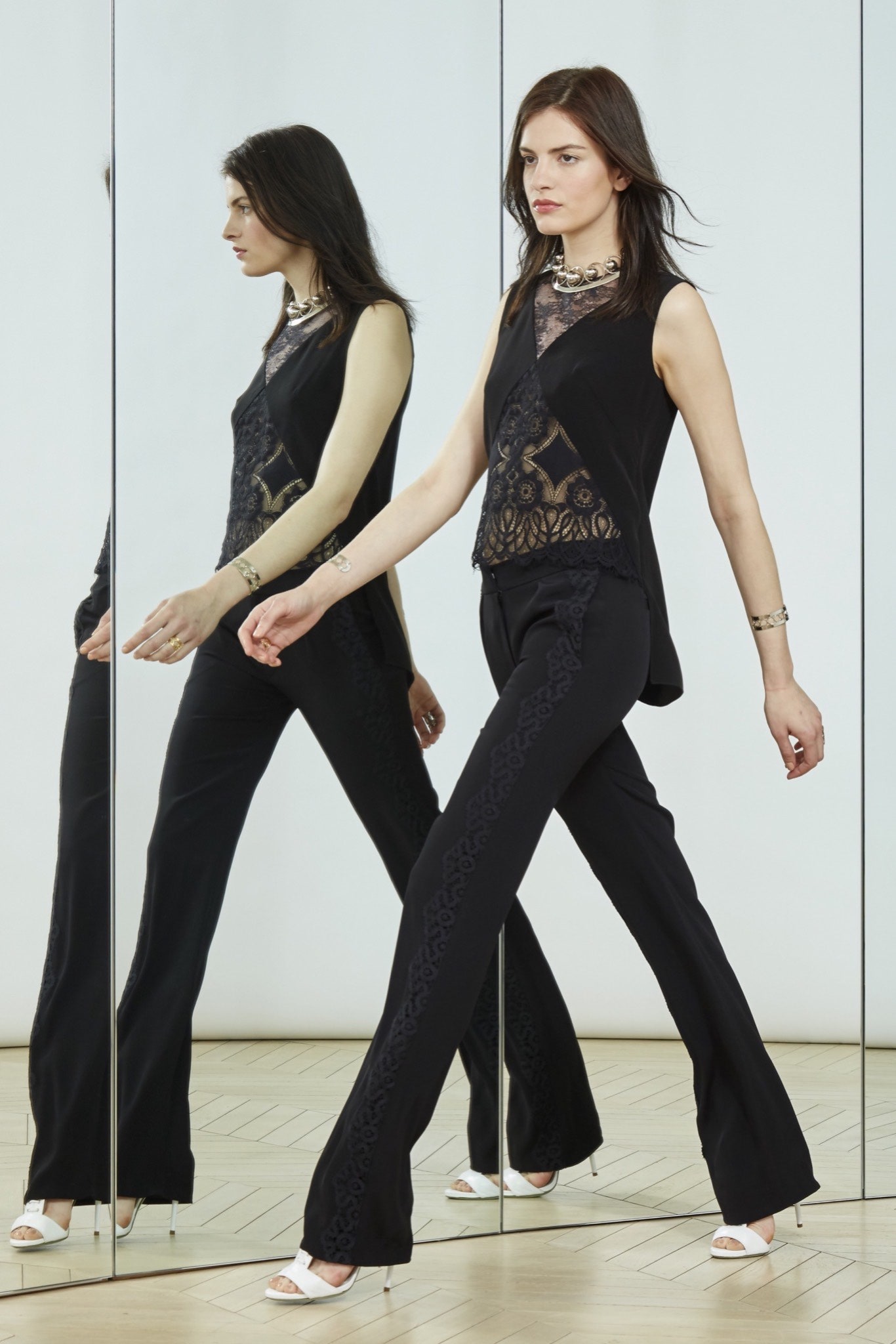 black lace sleeveless top and flared pants