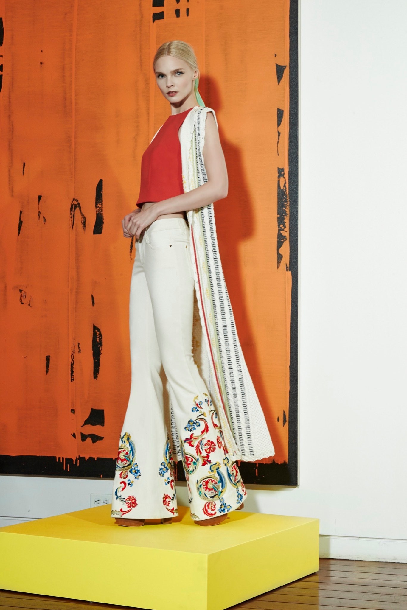 red fitted top with white flared pants