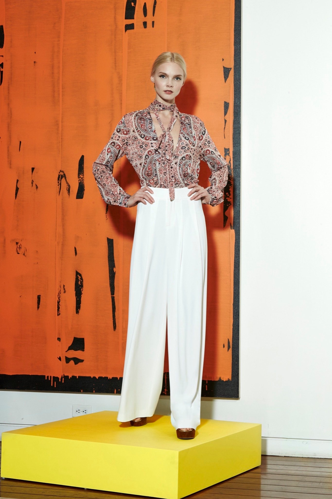 multi printed silk blouse and white tailored pants