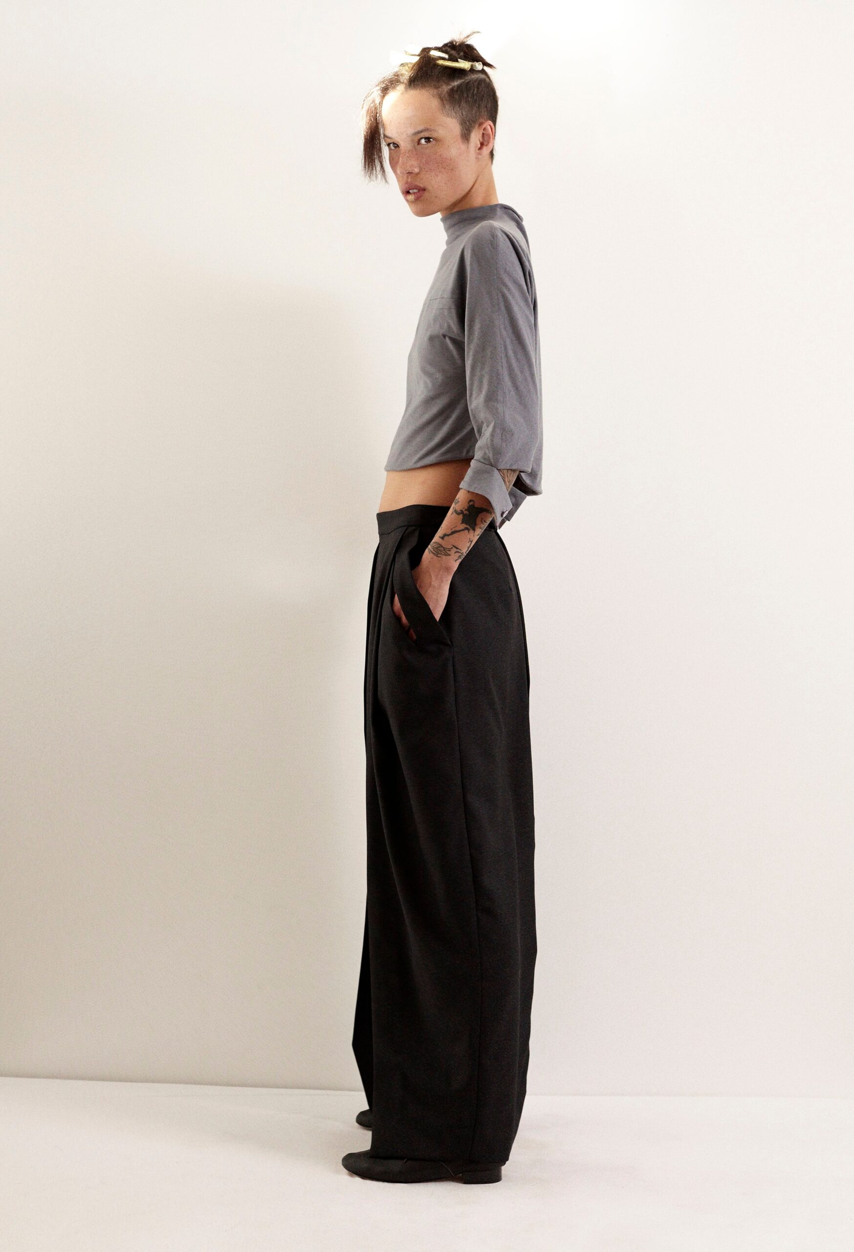gray cropped top and black wide-leg pants
