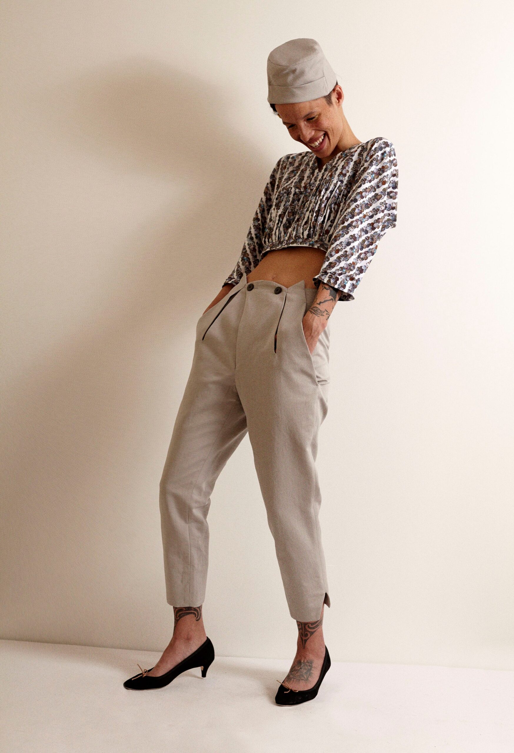 relaxed white and blue top with tailored beige pants