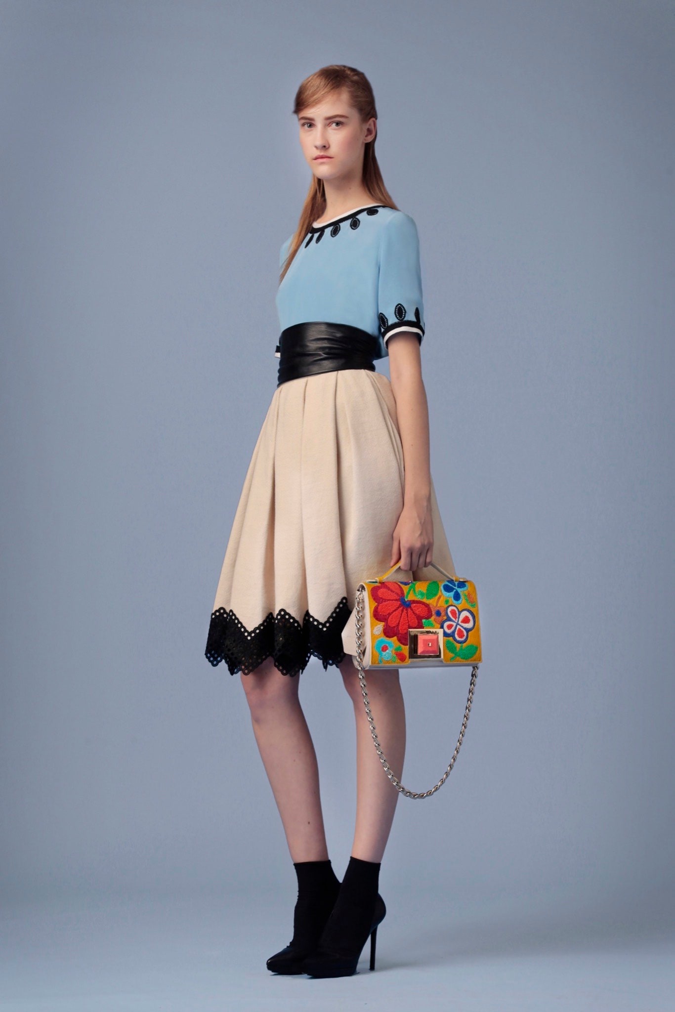 blue fitted top with beige skirt