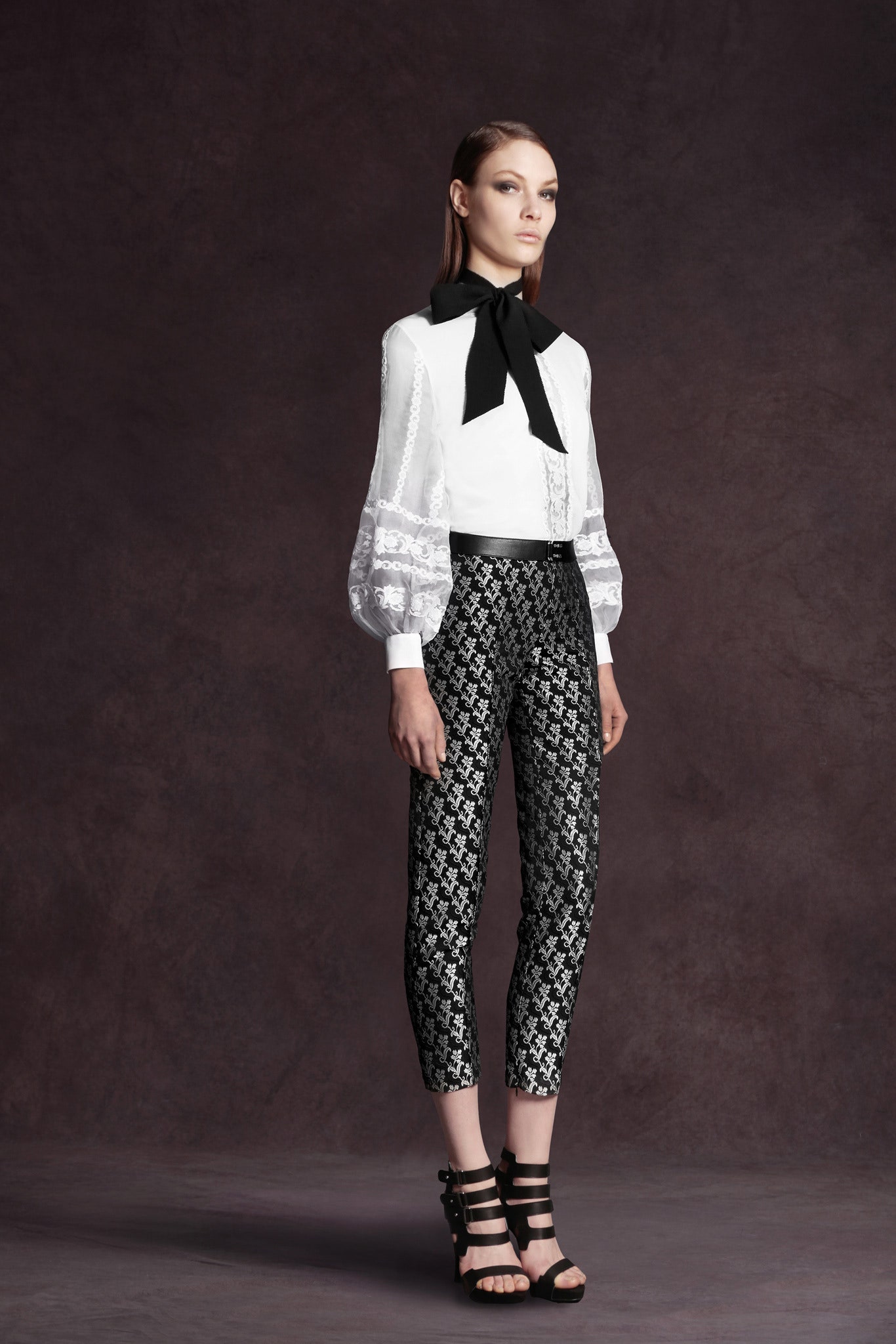 white ruffled blouse and black printed pants