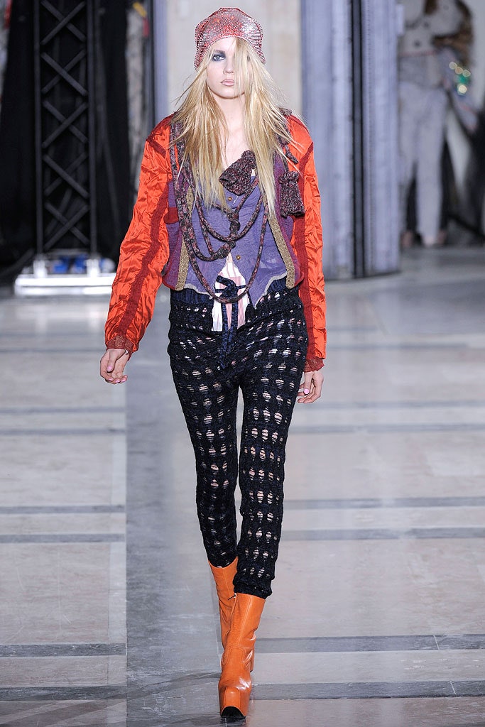 red jacket purple top black pants orange boots