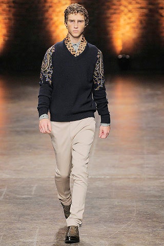 black embroidered sweater and beige pants