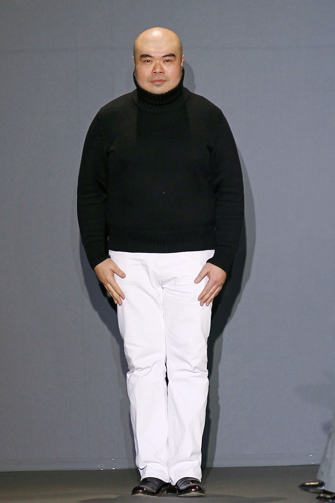 black wool turtleneck sweater and white pants