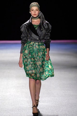 black silk structured jacket and green flared dress
