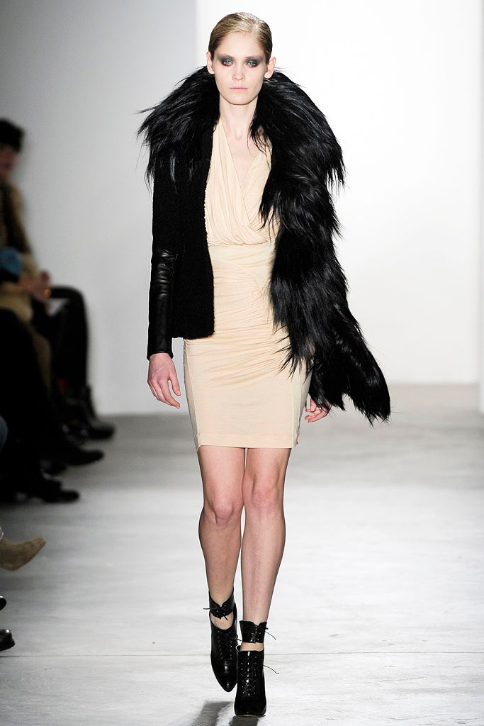 beige fitted mini dress with black faux-fur coat