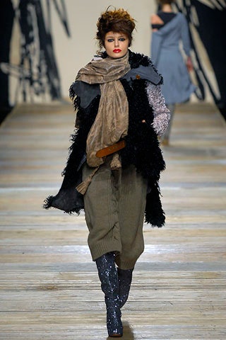 black faux-fur coat with beige scarf