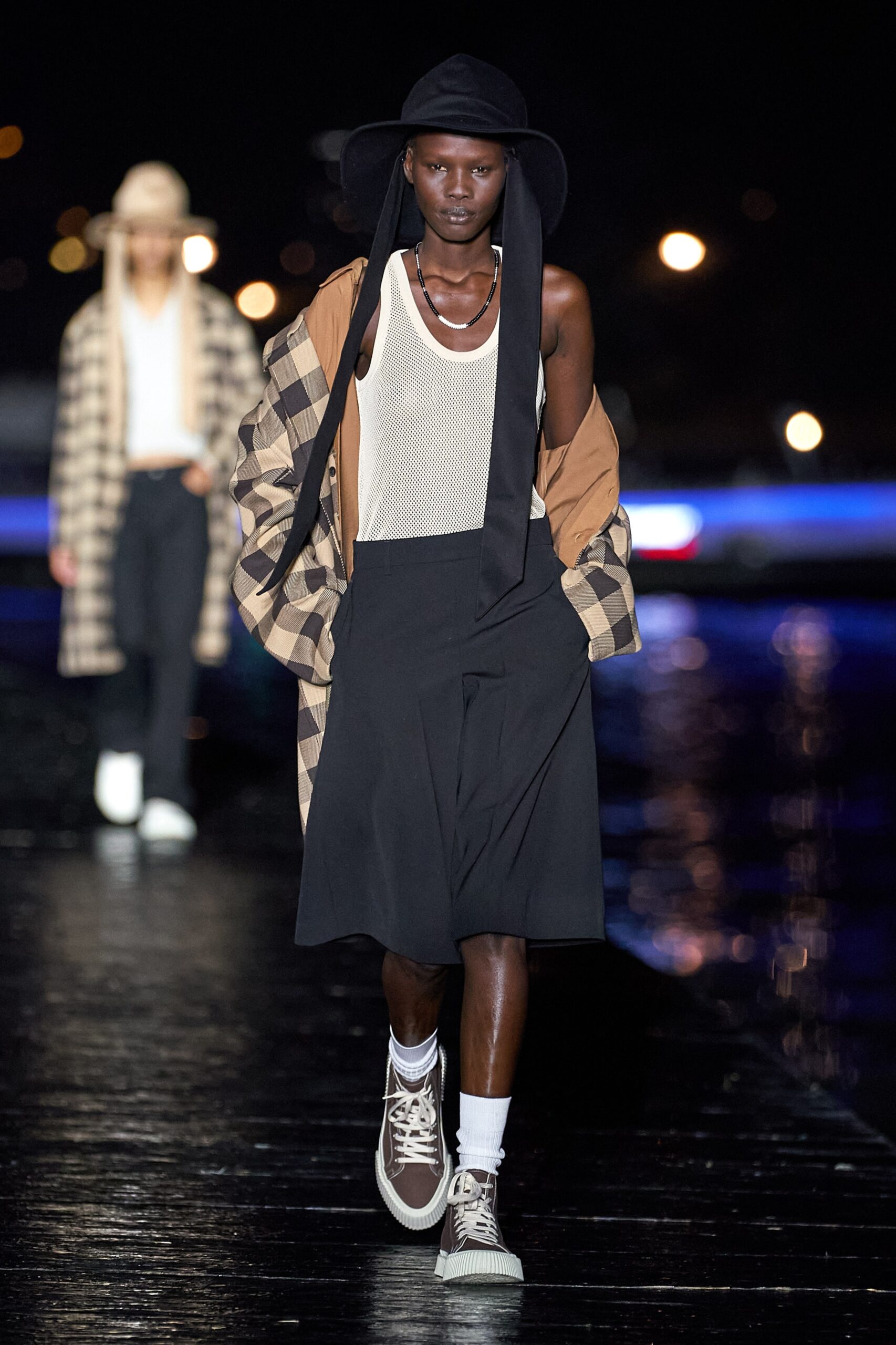 white sleeveless top with beige coat