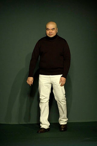 black wool turtleneck sweater and white tailored pants