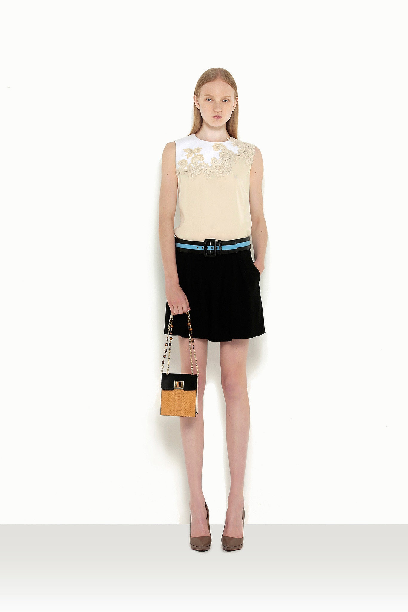 white silk sleeveless top with black pleated skirt
