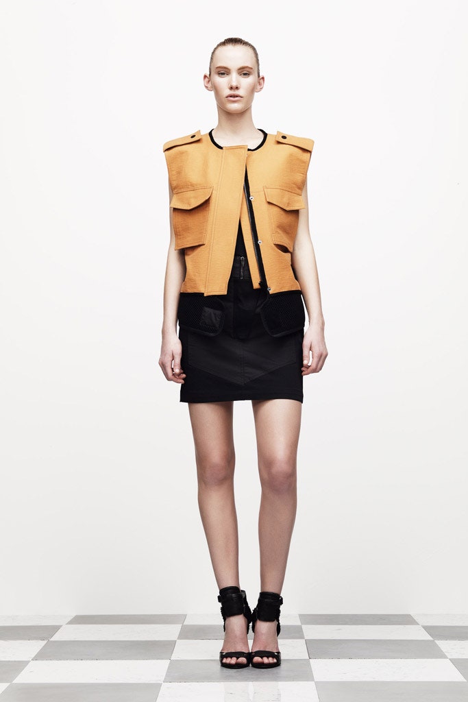 orange fitted jacket with black skirt