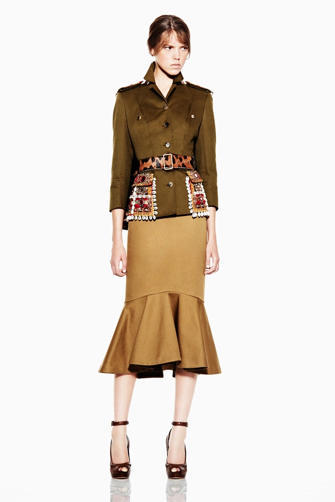 green fitted jacket with beige flared skirt