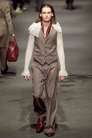 brown tailored suit with ruffled shirt