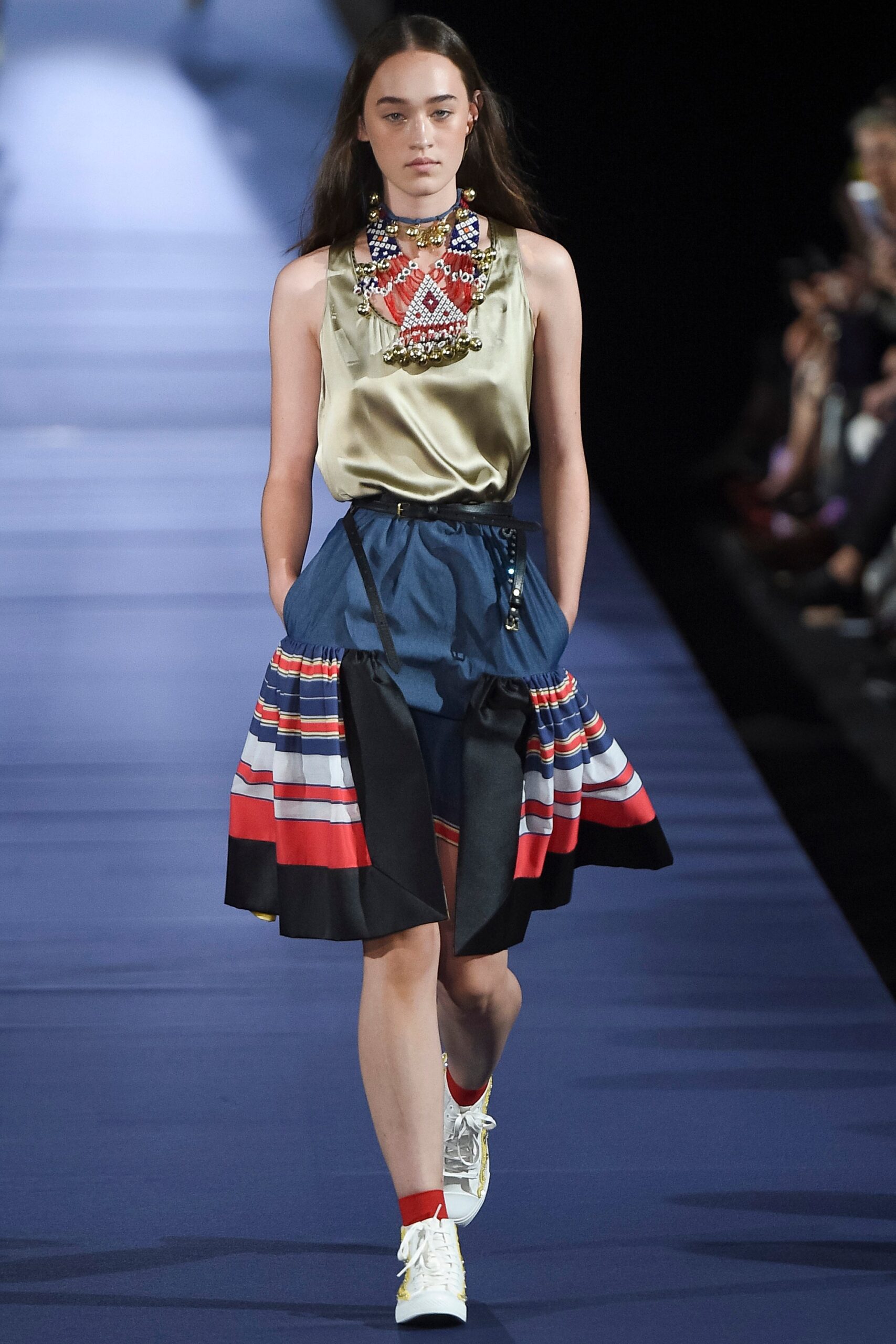 gold silk sleeveless top and pleated skirt