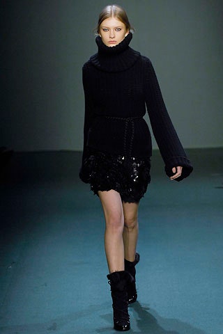 black fitted sweater and mini skirt