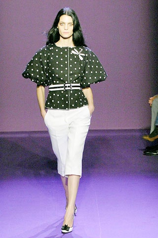 black polka-dot top with white pants