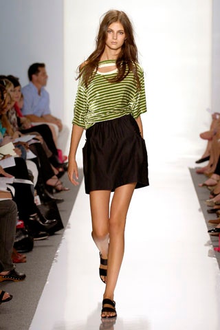 green striped relaxed top and black skirt