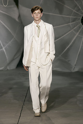 white tailored suit with green tie