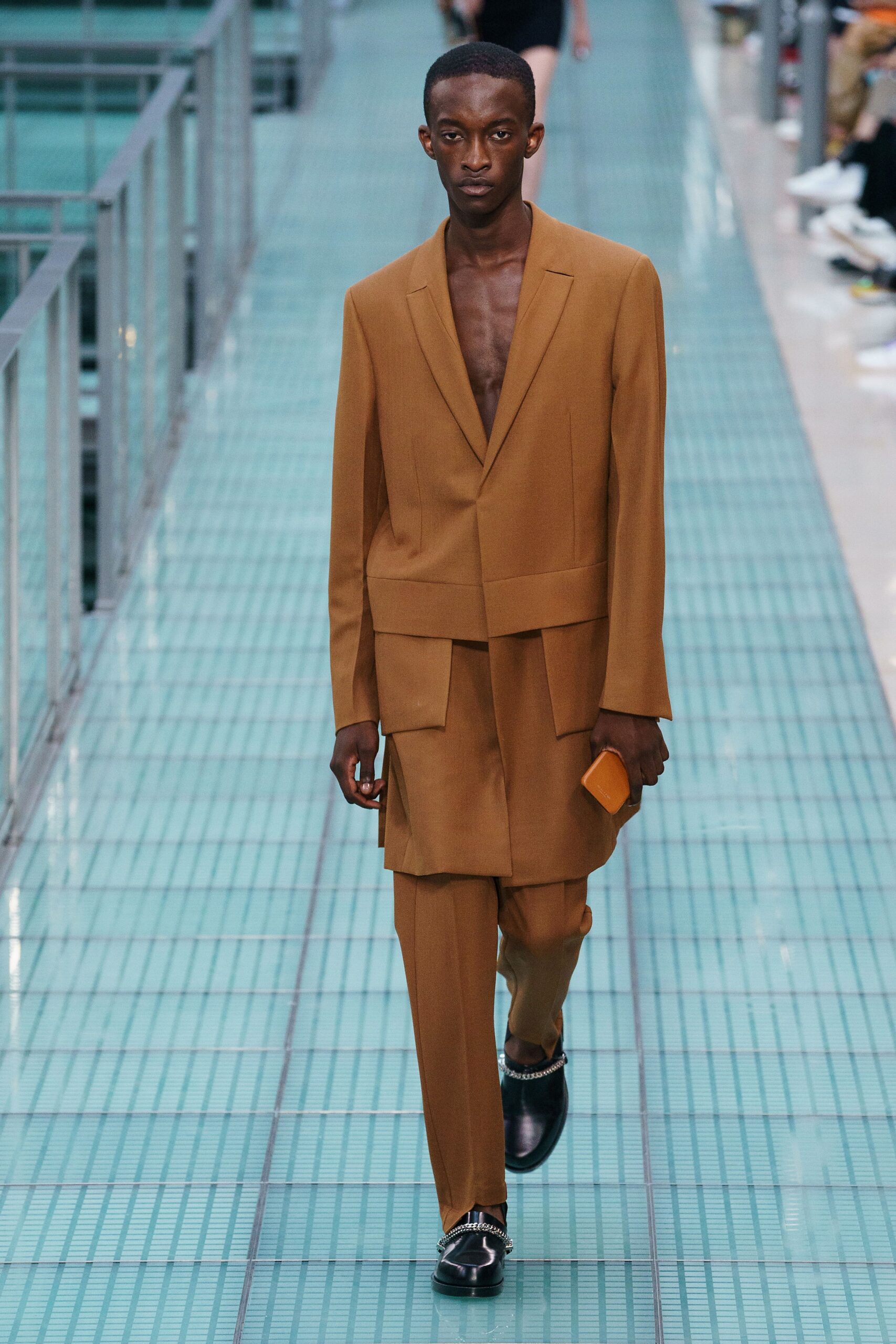 brown tailored suit with clutch