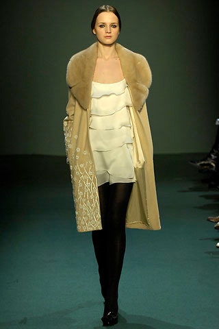 white ruffled dress with beige coat