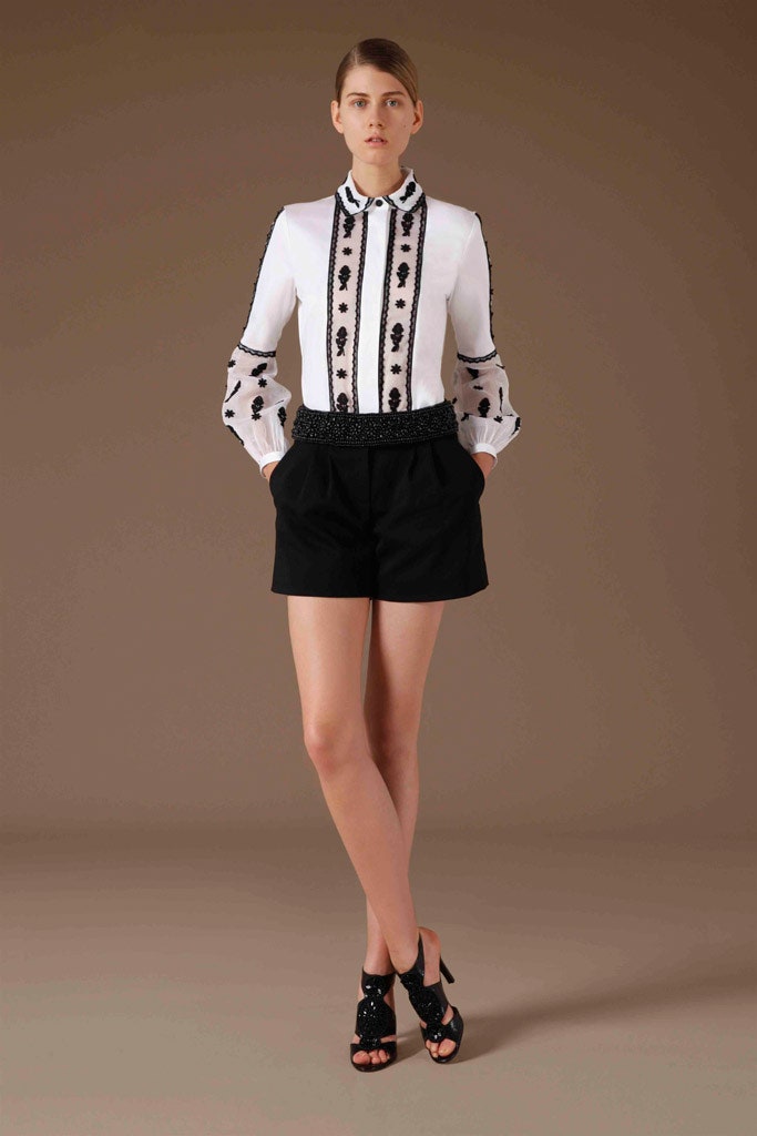 white embroidered blouse with black shorts