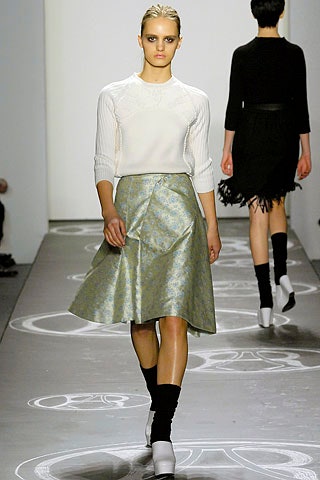 white fitted top with blue pleated skirt