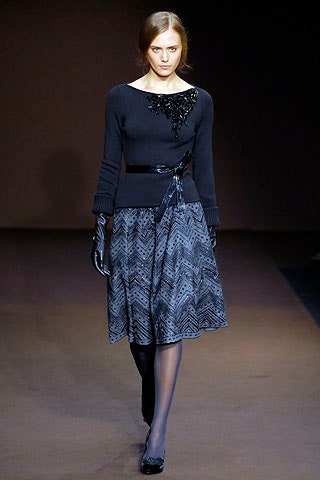 black fitted top and pleated skirt