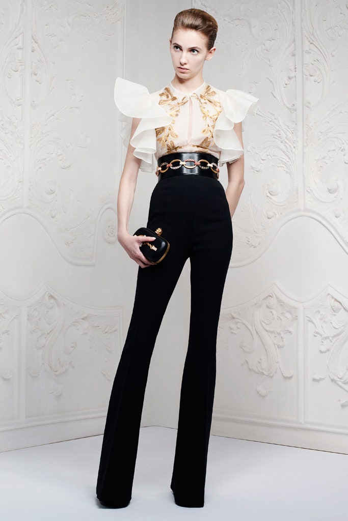 white ruffled top and black flared pants