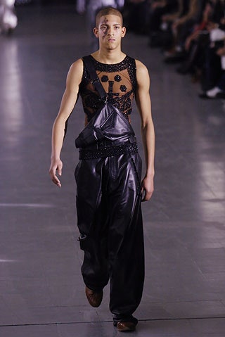 black embellished sleeveless top and relaxed leather pants