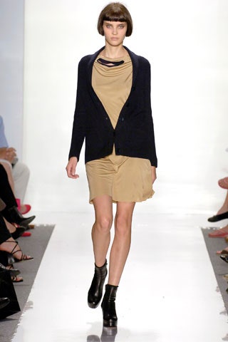 beige fitted mini dress with black cardigan