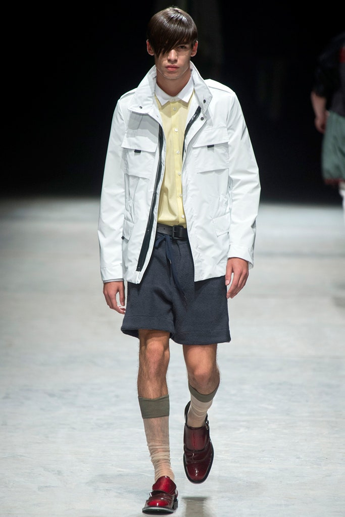 white jacket yellow shirt navy shorts