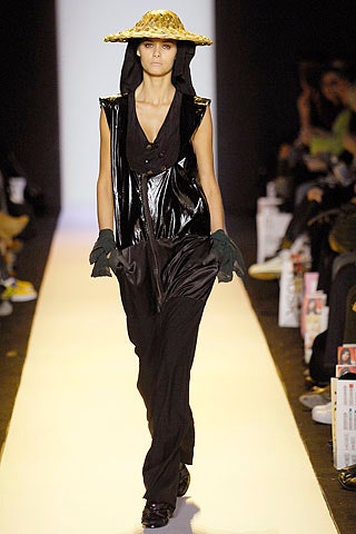 black vinyl fitted jumpsuit with gold hat