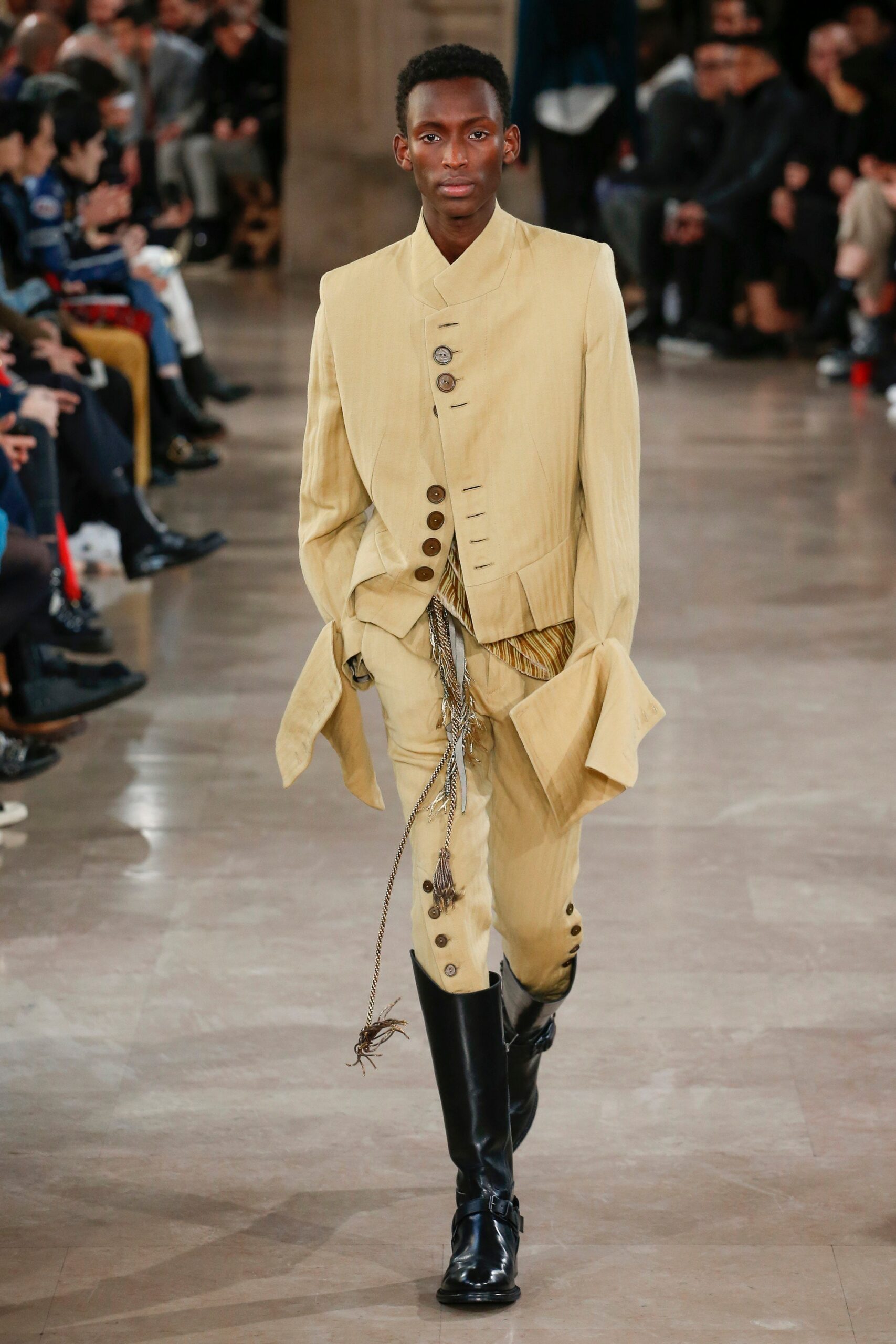 beige tailored suit with black boots