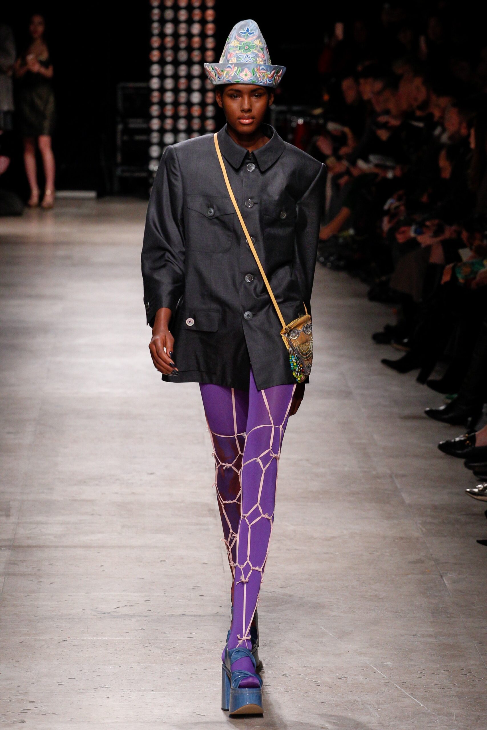 black tailored jacket with purple pants
