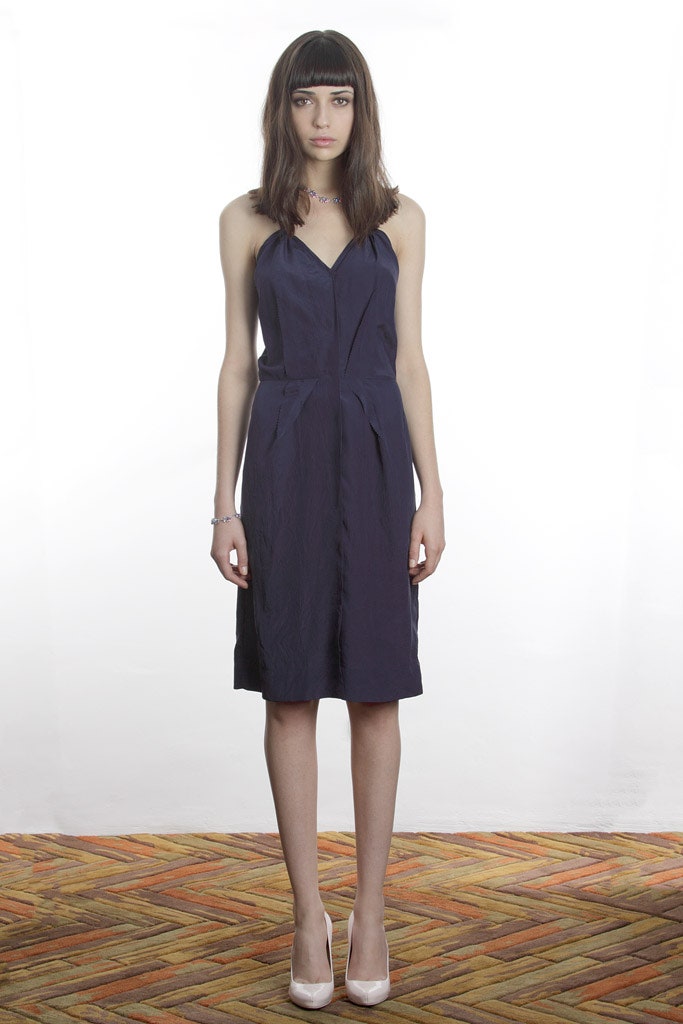 blue fitted sleeveless dress with white shoes