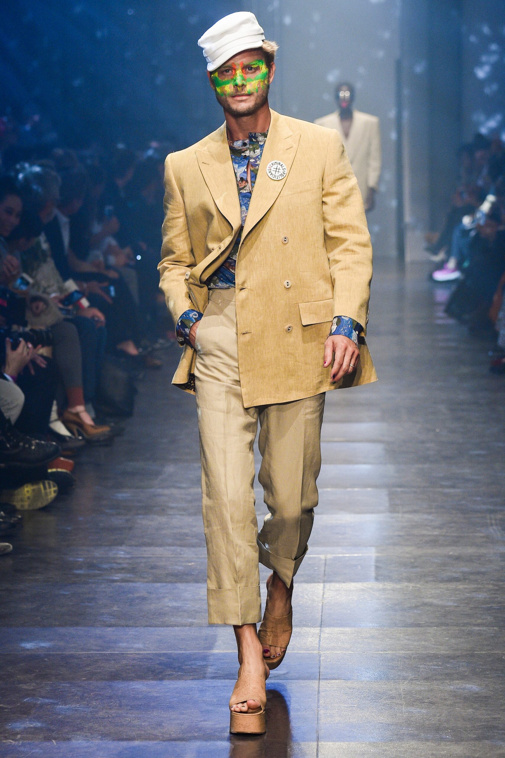 beige tailored suit with blue shirt