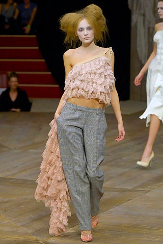 pink ruffled top with gray pants