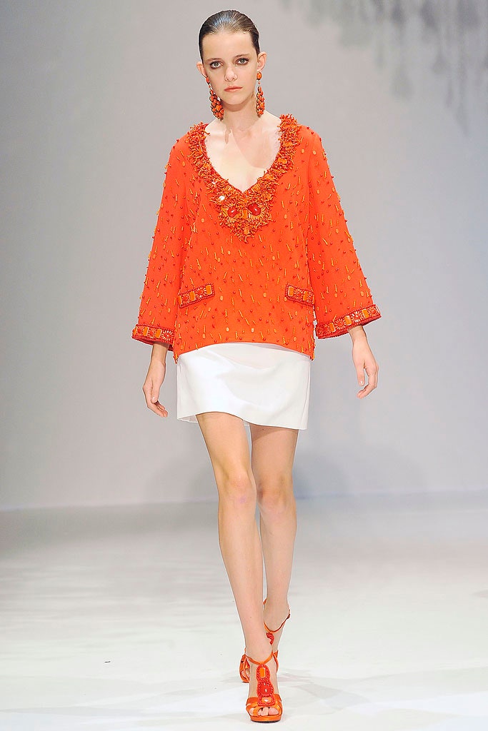 orange embroidered top with white mini skirt