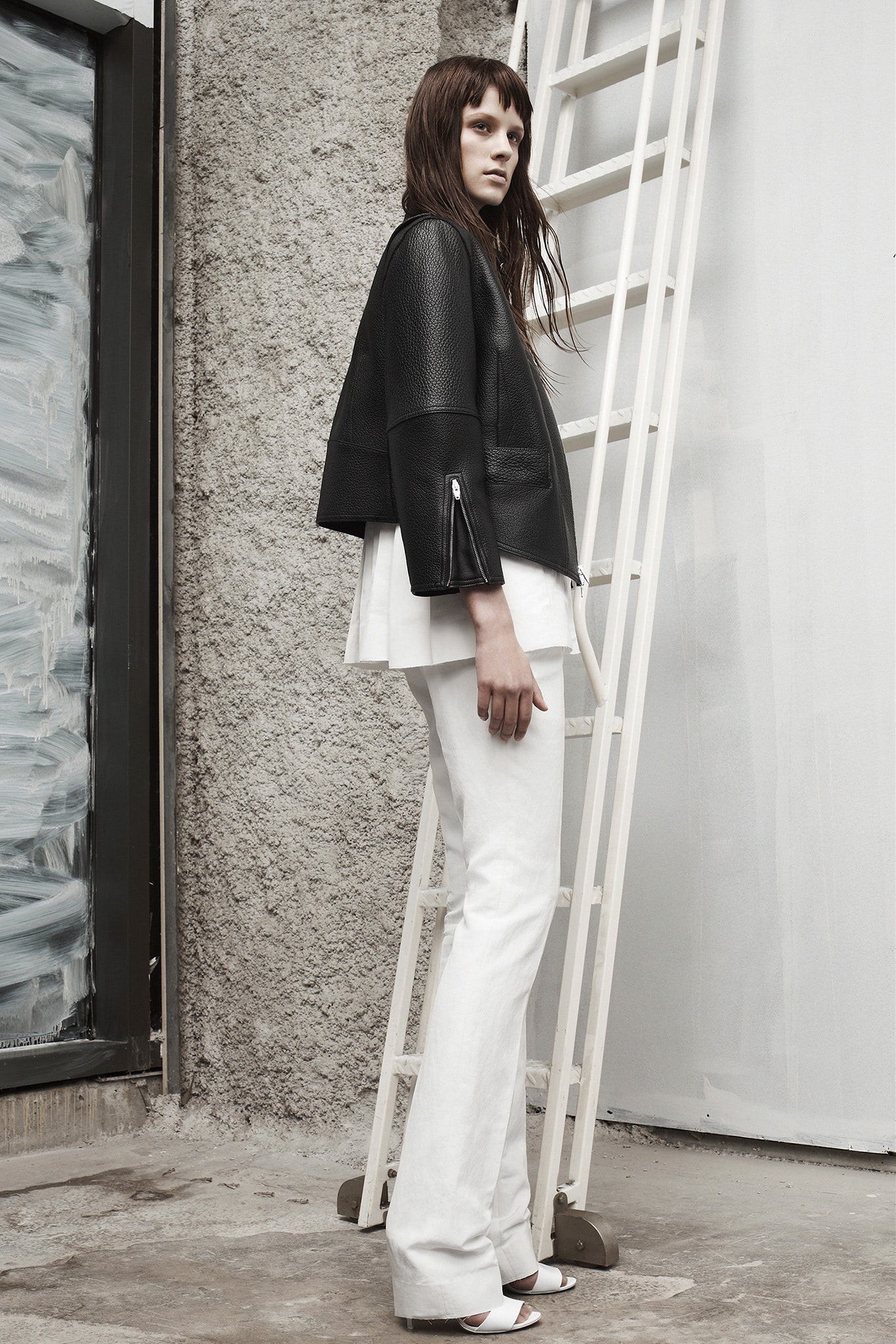 black leather fitted jacket with white top and flared pants