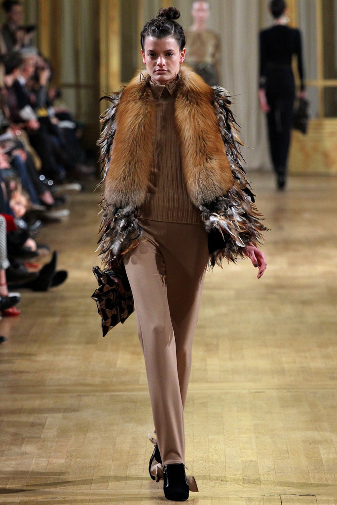 beige fitted top with brown fur cape