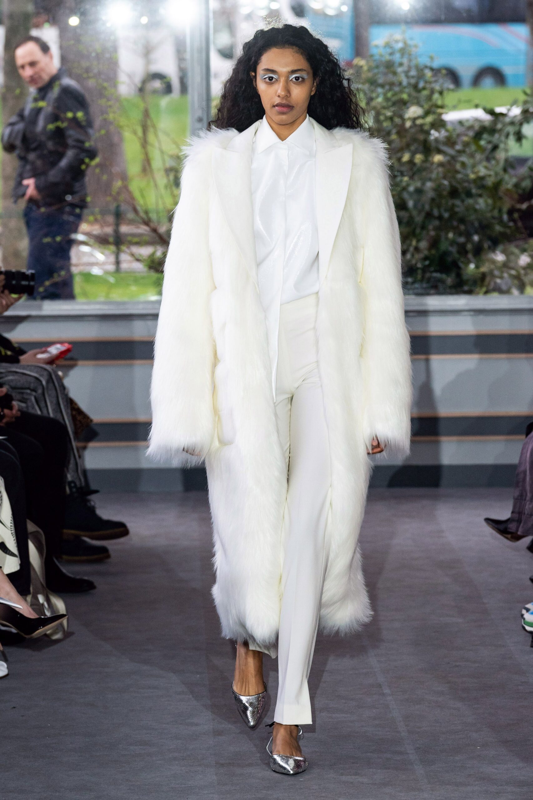white faux-fur coat with tailored pants