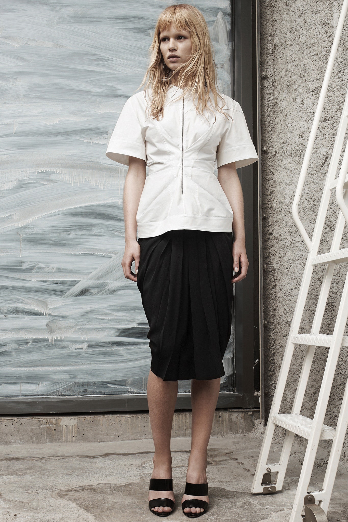 white fitted top black pleated skirt